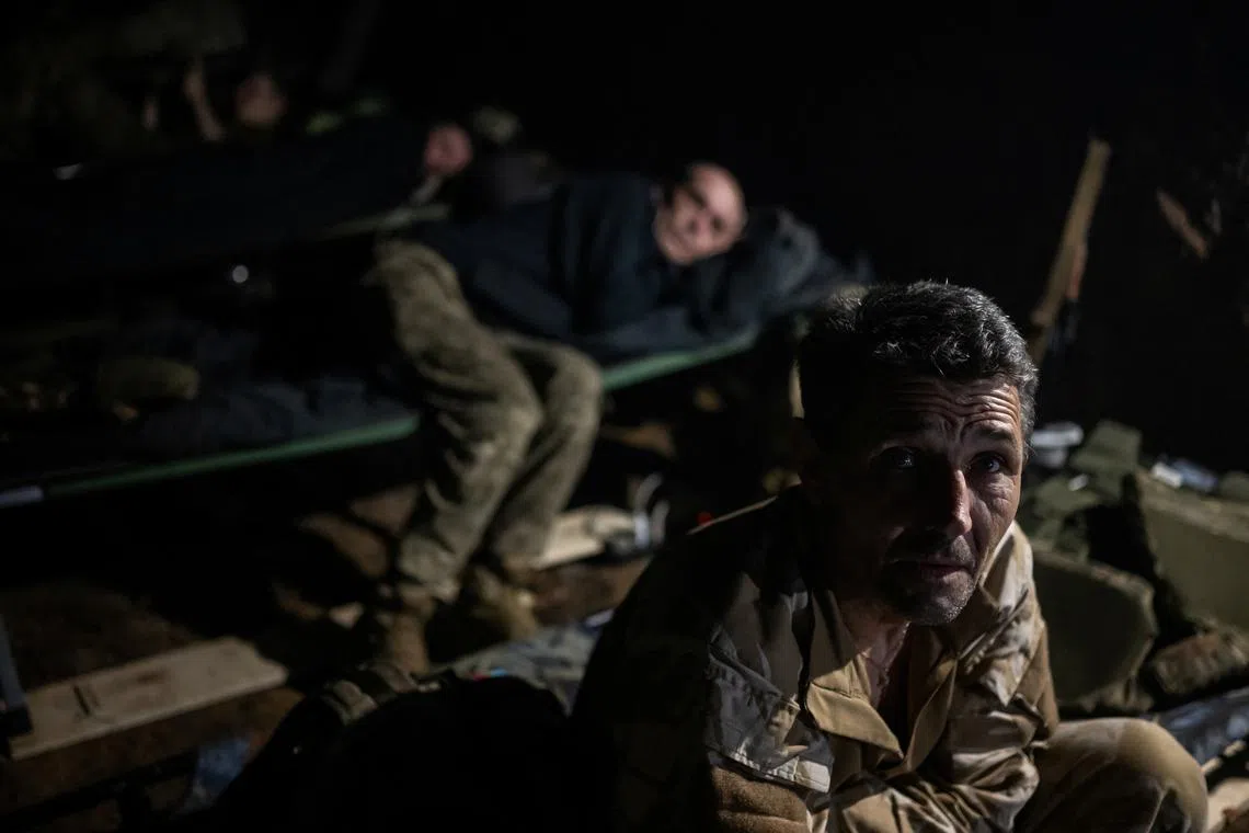 Artillerymen of the 42nd Separate Mechanized Brigade of the Armed Forces of Ukraine rest inside a dugout, amid Russia's attack on Ukraine, on the front line, near the town of Vovchansk in the Kharkiv region, June 12, 2024. REUTERS/Viacheslav Ratynskyi