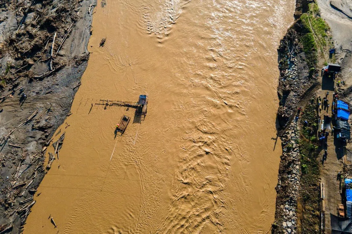 People rafting across the Peusangan river in the aftermath of flash floods that destroyed villages in Aceh province on Jan 5.