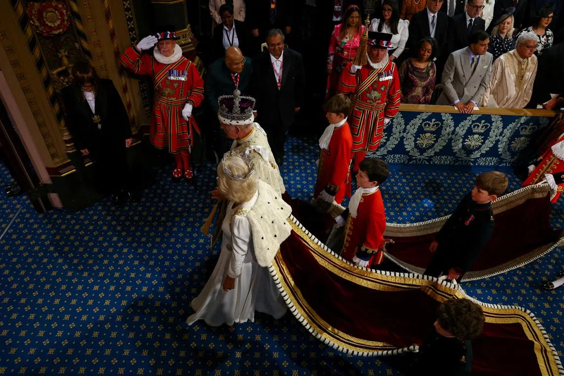 Britain's King Charles, wearing the Imperial State Crown, and Queen Camilla, wearing the Diamond Diadem, walk during a ceremony on the day of the State Opening of Parliament at the Palace of Westminster in London, Britain, on July 17, 2024.