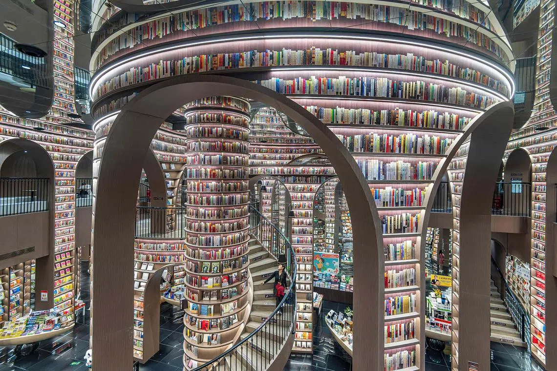 TOPSHOT - A woman visits a bookstore in Chengdu, in southwestern China's Sichuan province on October 13, 2024. (Photo by AFP) / China OUT