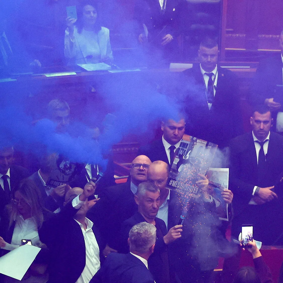 A person holds a flare as members of parliament from the Democratic Party, Albania's biggest opposition party, protest against the government inside the parliament in Tirana, Albania, October 29, 2026. REUTERS/Florion Goga