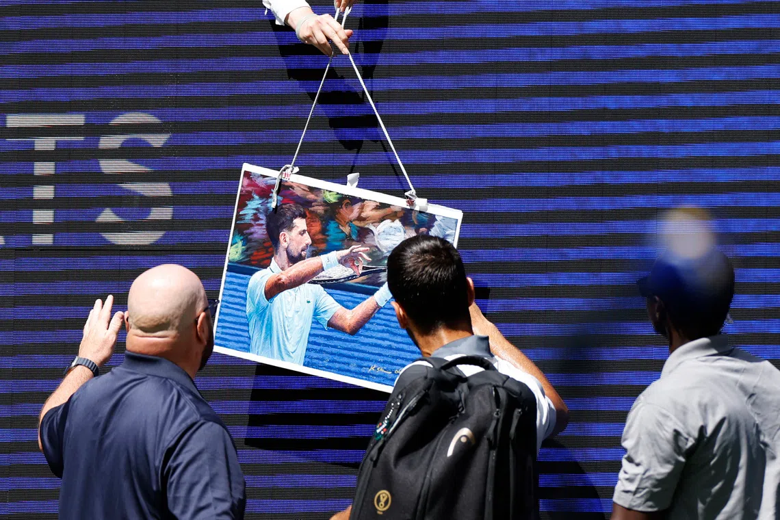 Tennis - U.S. Open - Flushing Meadows, New York, United States - August 25, 2026 Serbia's Novak Djokovic signs autographs for fans after his mixed doubles round of 16 match with Belarus' Aryna Sabalenka against Britain's Henry Patten and Czech Republic's Katerina Siniakova REUTERS/Eduardo Munoz