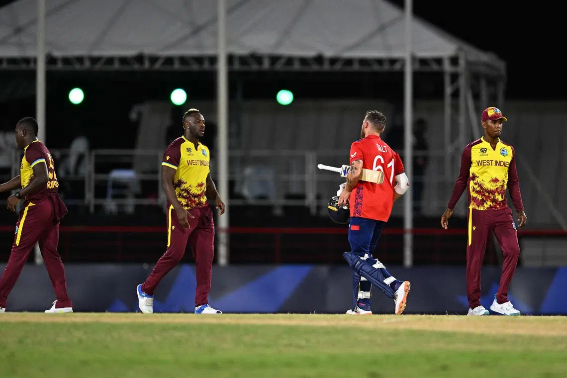 West Indies' Andre Russell and England's Phil Salt about to shake hands after England won the ICC men's Twenty20 World Cup Super Eight cricket match at Daren Sammy National Cricket Stadium in Gros Islet, Saint Lucia, on June 19, 2024.
