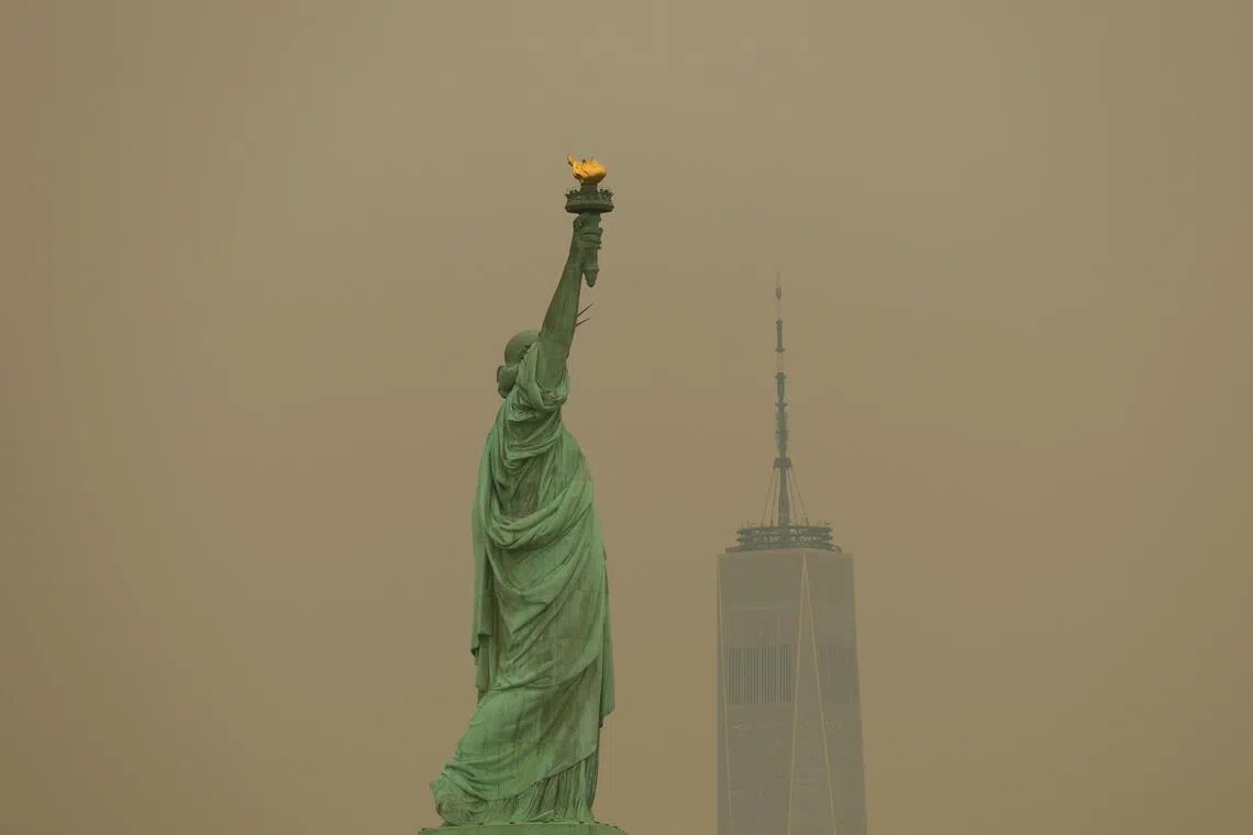 New York’s Statue of Liberty seen through the haze of wildfire smoke on July 16.