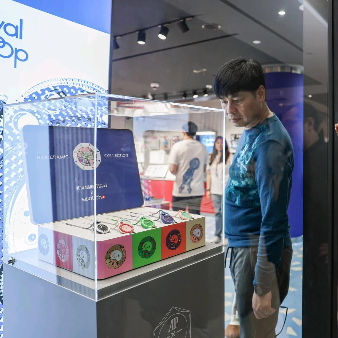 Shoppers looking at the Royal Pop watch collection, a collaboration between Swatch and Audemars Piguet, at the Swatch ION Orchard outlet on May 16, 2026. ST PHOTO: BRIAN TEO