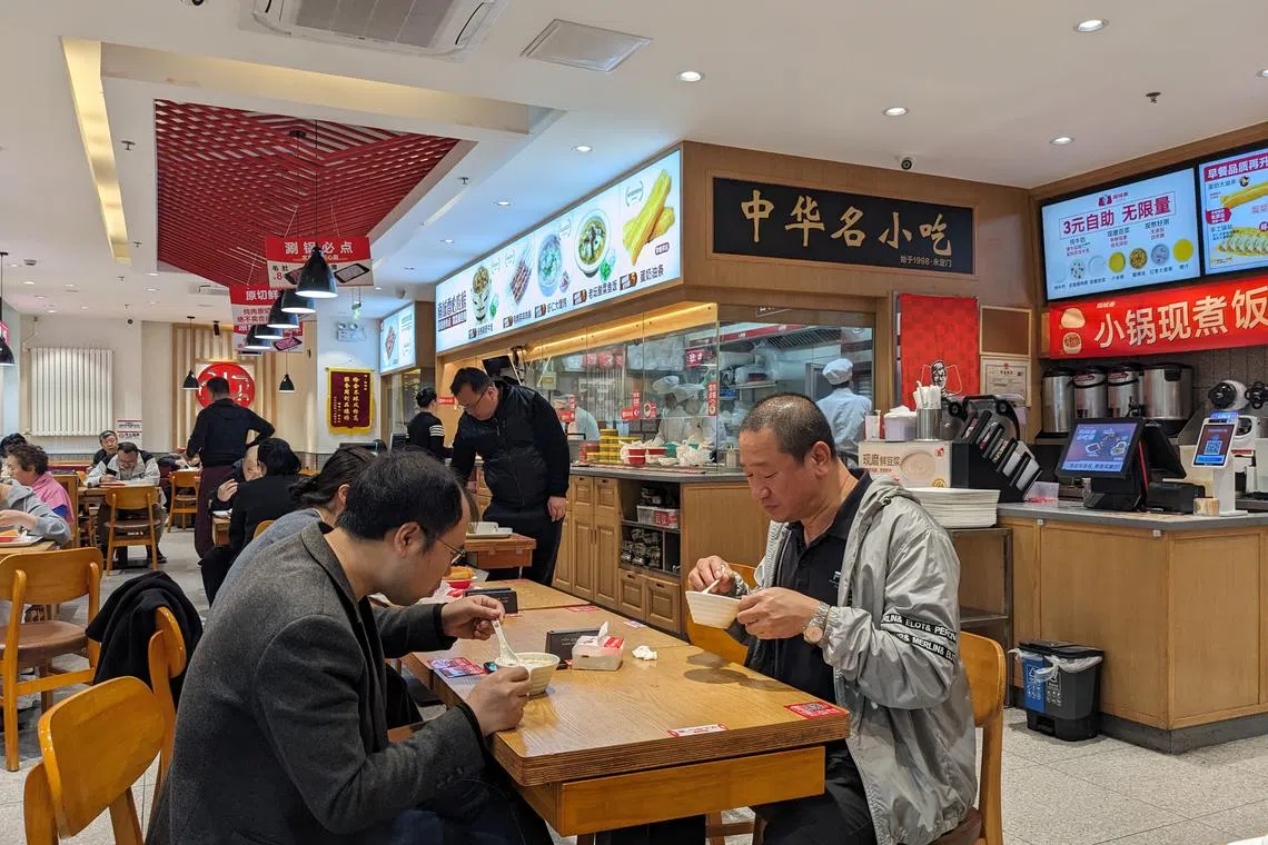 Two men enjoy a three-yuan breakfast at a Nanchengxiang outlet in Beijing.
