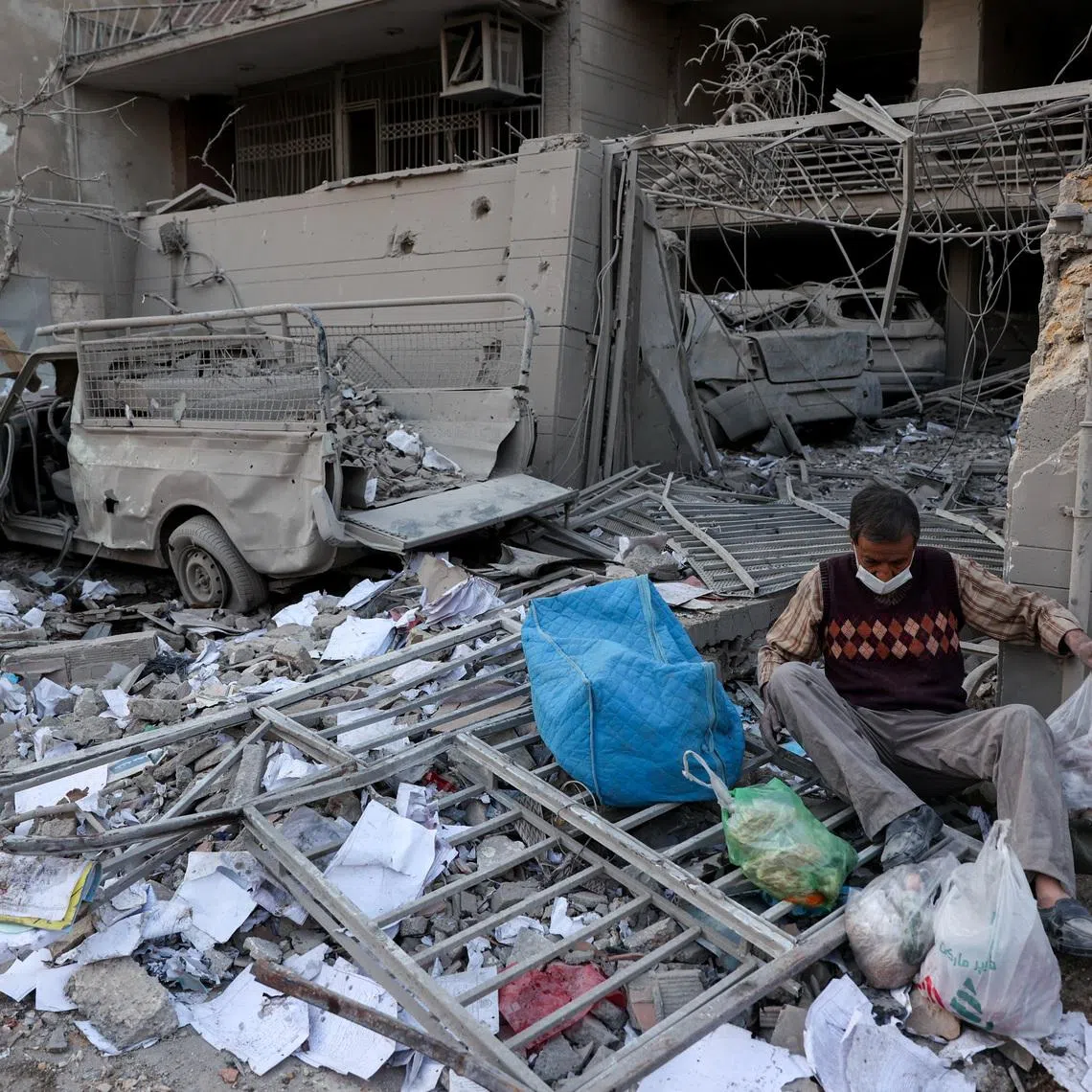A person sits amid debris following an Israeli and U.S. strike on a police station, amid the U.S.-Israel conflict with Iran, in Tehran, Iran, March 2, 2026. Majid Asgaripour/WANA (West Asia News Agency) via REUTERS