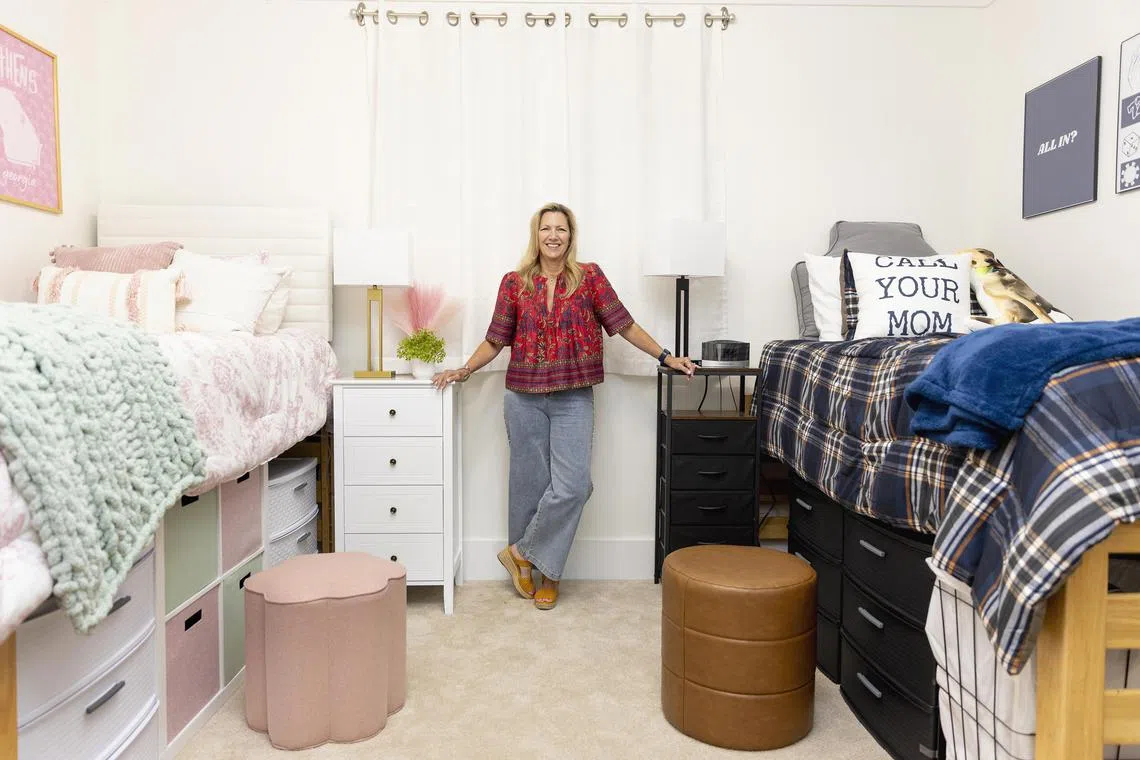 Lara Becker, who built an at-home model dorm room to test products and make videos of her rigorously researched tips, in Milton, Ga., on Aug. 15, 2025. Influencers are making money online by recommending dorm products and designs to families, who spend thousands of dollars on back-to-college shopping. (Kendrick Brinson/The New York Times)
