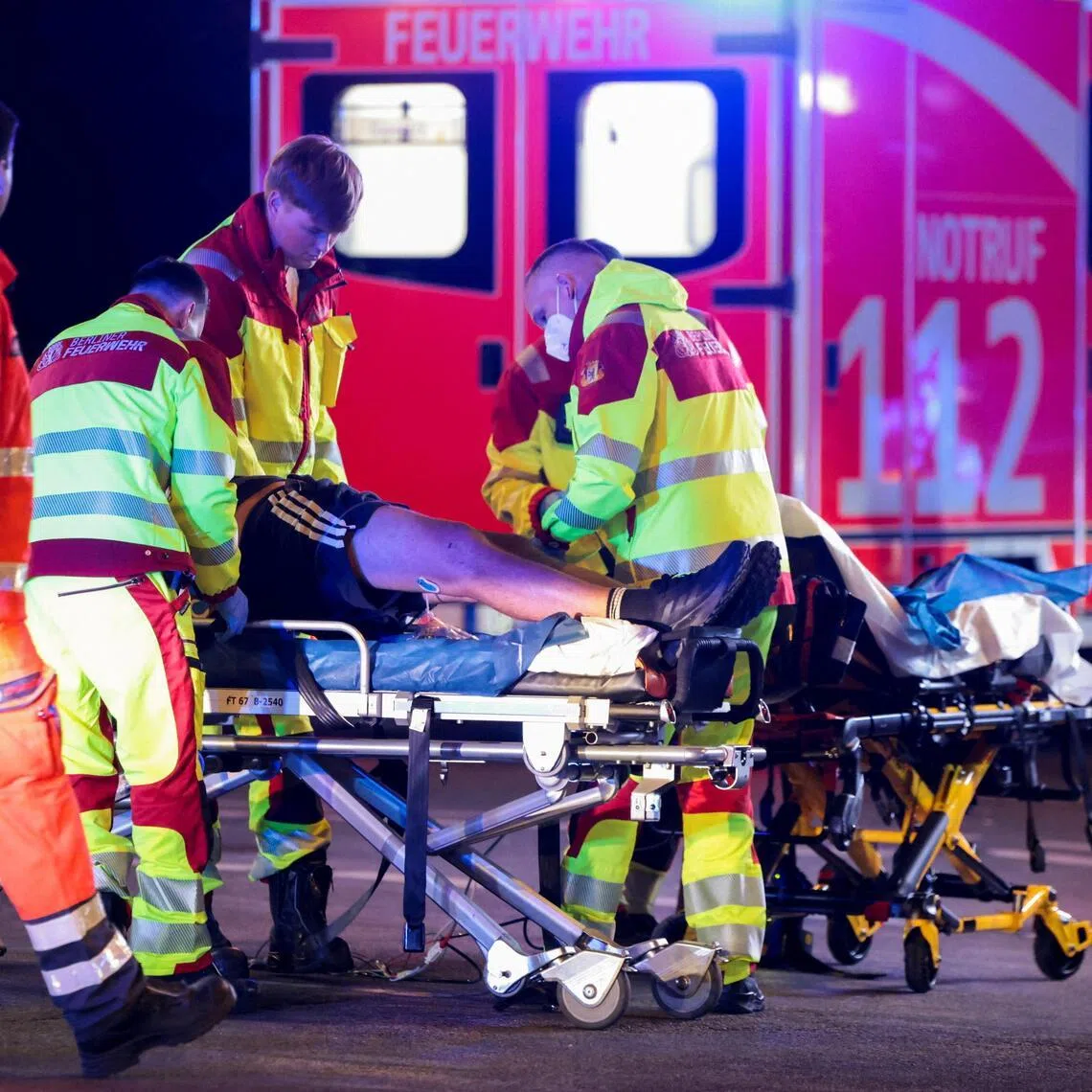 Emergency responders helping people in Berlin after a car hit a  crowd on July 25.