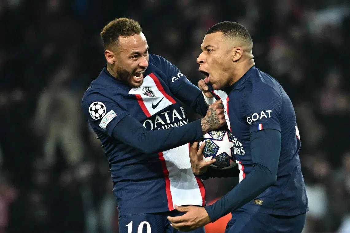 Paris Saint-Germain's French forward Kylian Mbappe celebrating with teammare Neymar after scoring a goal that was later ruled offside during the Champions League game against Bayern Munich.