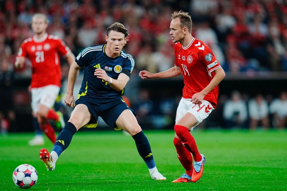 Scotland's Scott McTominay (left) and Denmark's Mikkel Damsgaard vie for the ball during their World Cup qualifier.