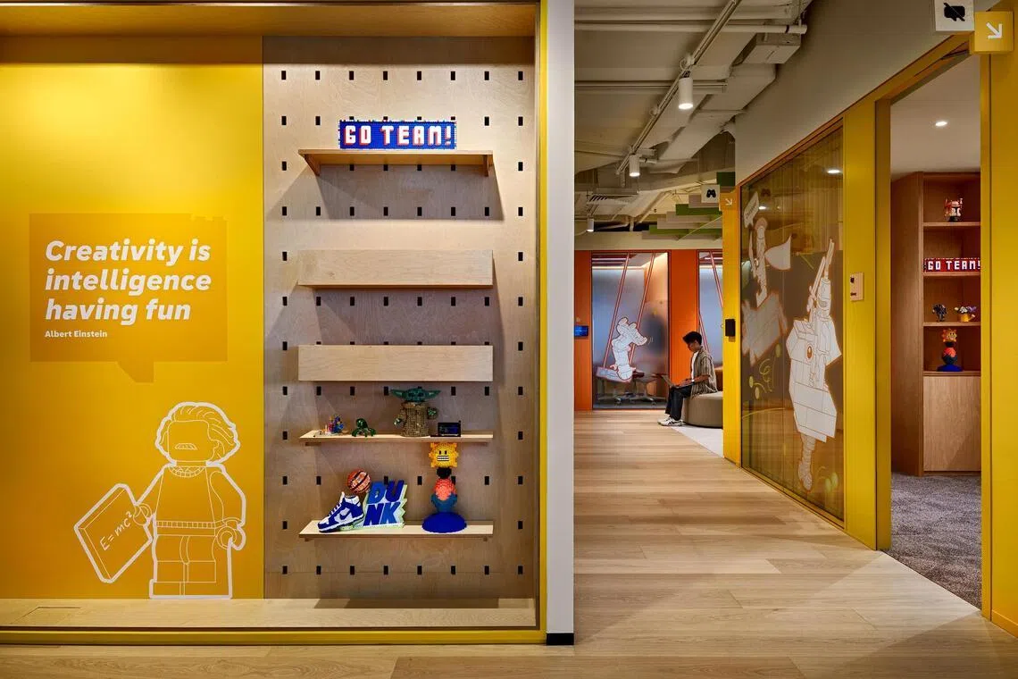 A Lego “minifig” of physicist Albert Einstein lines a wall in the yellow zone.