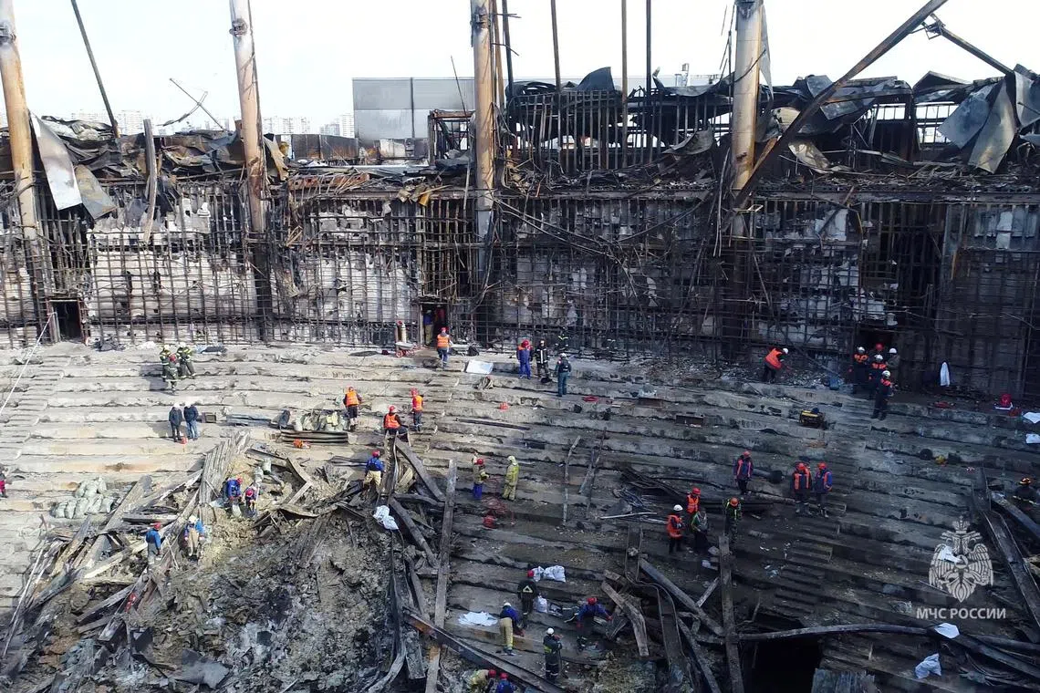 Members of the Russian Emergencies Ministry and workers remove debris inside the burnt-out Crocus City Hall following a deadly attack on the concert venue outside Moscow, Russia, in this still image taken from video released March 26, 2024. Russian Emergencies Ministry/Handout via REUTERS