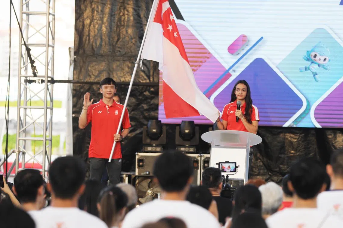 Asian Games flagbearer Jowen Lim (left) holding the Singapore flag while reciting the athletes' pledge with Amita Berthier at the Official Flag Presentation Ceremony for the Hangzhou Asian Games on Saturday.

ST PHOTO: KELVIN CHNG