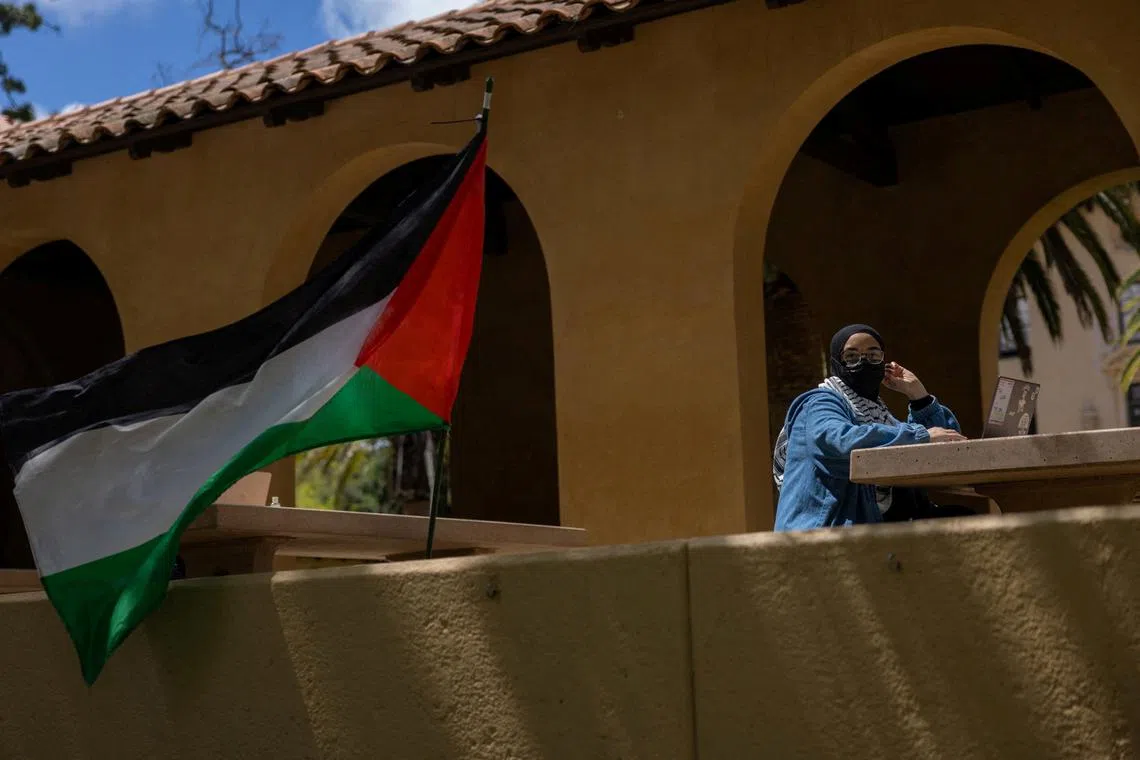 FILE PHOTO: A student attends an event at a protest encampment in support of Palestinians at Stanford University during the ongoing conflict between Israel and the Palestinian Islamist group Hamas, in Stanford, California U.S., April 26, 2024. REUTERS/Carlos Barria/File Photo