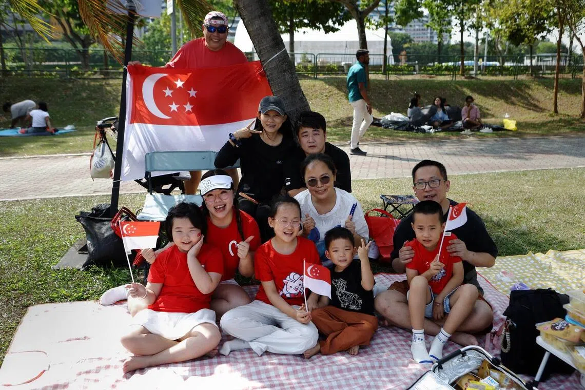 Ho Kien Mun (behind flag), with (first row from left) Ang Shihui, Yifan, Duoduo, Yiji, (second row from left) Zhang Sijuan, Li Ting, Jacky Wang, (third row from left) Dan Na Wu, and Howard Yang, at Republic Avenue on Aug 9.