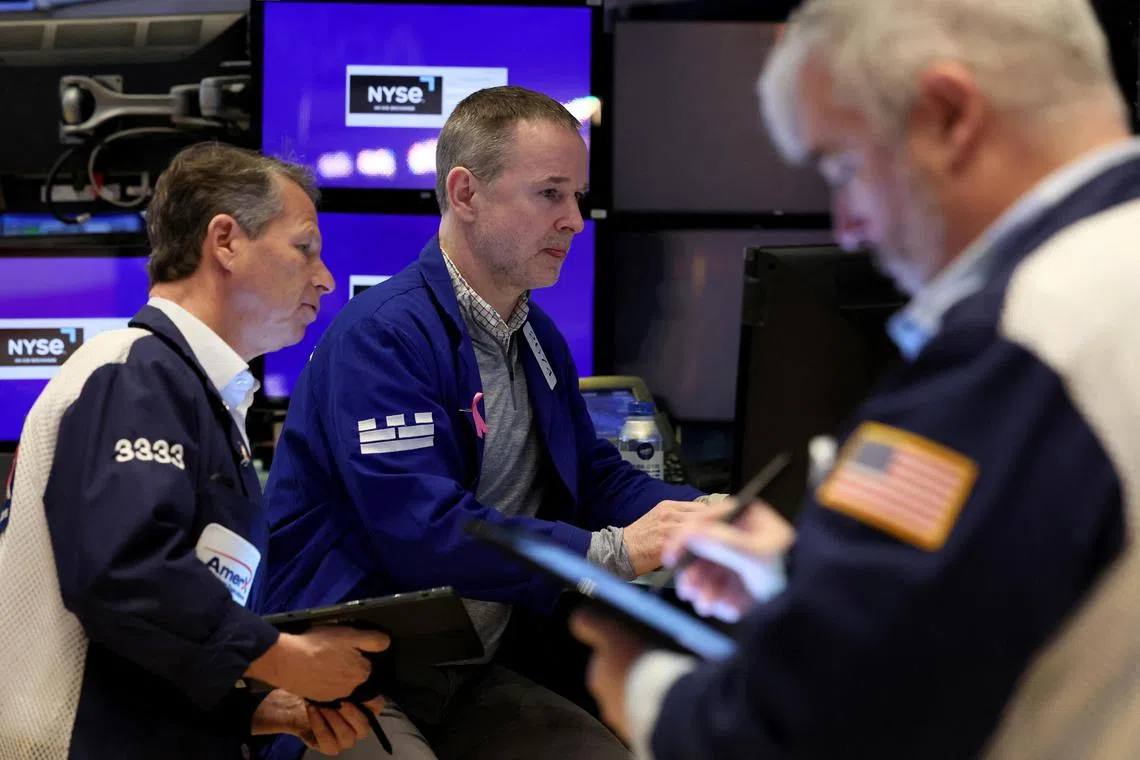Traders work on the floor at the New York Stock Exchange, in New York City.