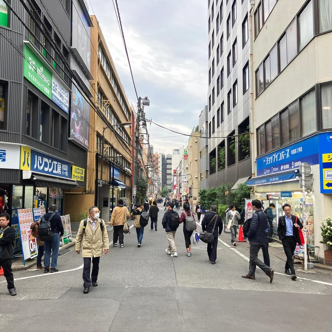 People walk on a back street in Akihabara, Tokyo, Japan, Nov 13, 2025.