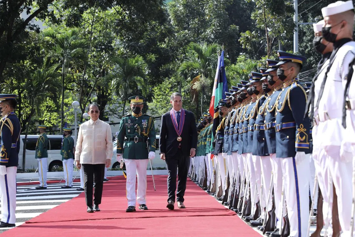 (From left) Philippines Defense Secretary Carlito Galvez, Australian Deputy Prime Minister and Minister of Defense Richard Marles walking past military honor guards during arrival honors at the DND compound in Quezon City, Metro Manila, on Feb 22, 2023.