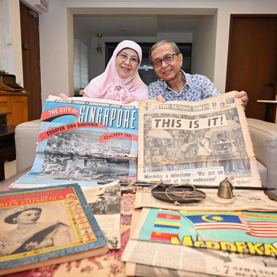 Ms Hernie Lim and her husband, Mr Hassim Mokhtar, with their old copies of The Straits Times.