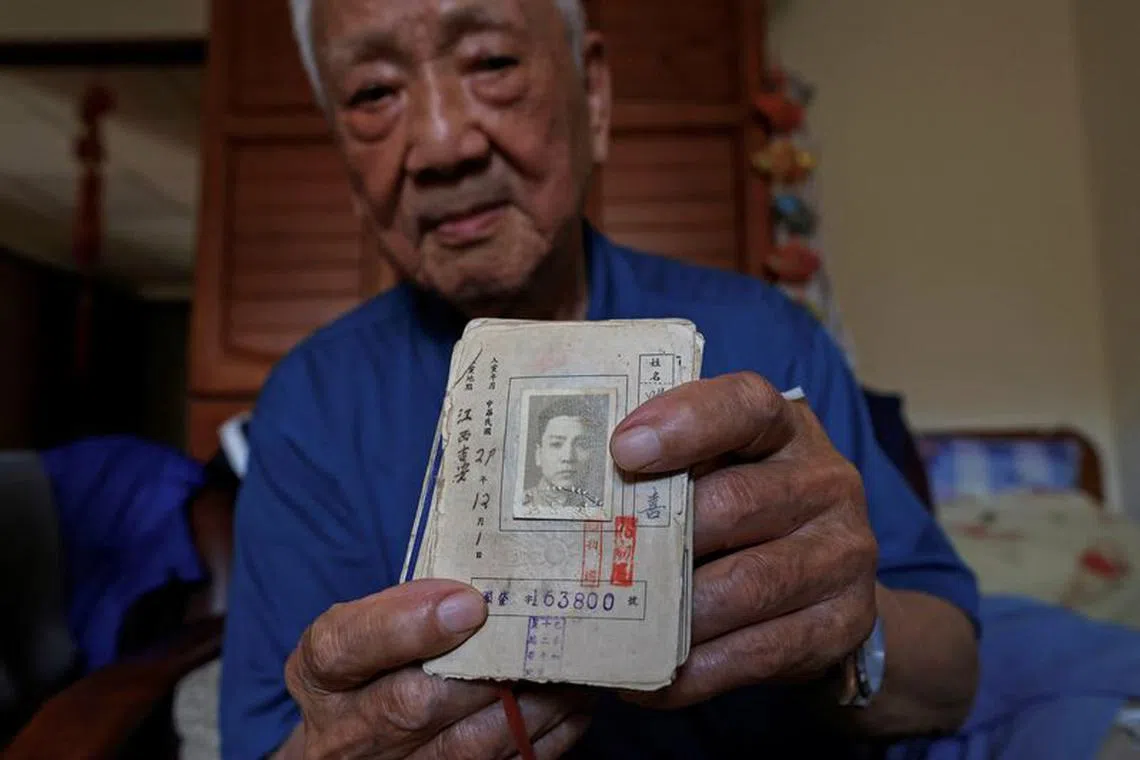 Sun Kuo-hsi, 110, poses with his Kuomintang party membership card, which states he joined the party in 1940, in his room at the Taoyuan Veterans home in Taoyuan, Taiwan November 6, 2023. Sun vividly remembers the chaos of the final years of the Chinese Civil War and the government forces he fought for collapsing in front of Mao Zedong's Communists, forcing him to flee by boat to Taiwan in 1949 in a perilous eight-day crossing. "There was no dock. Everyone was splashing around in the water," Sun told Reuters. "Talking about it with young people now, they've not been through that time, they don't care, say it's in the past. Nobody listens," said Sun, one of the last generation in Taiwan to have fought against China and experience war.  REUTERS/Ann Wang