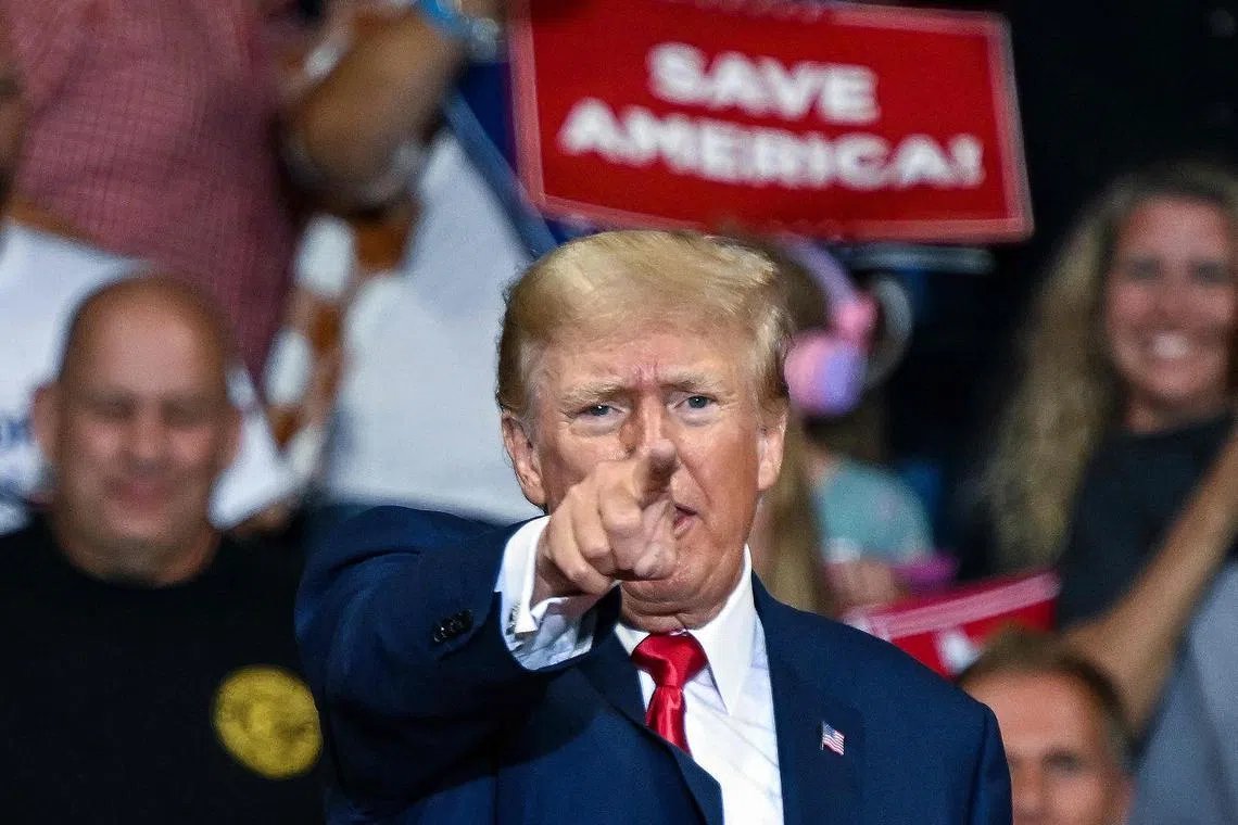 (FILES) In this file photo taken on September 03, 2022, former US President Donald Trump speaks during a campaign rally in support of Doug Mastriano for Governor of Pennsylvania and Mehmet Oz for US Senate at Mohegan Sun Arena in Wilkes-Barre, Pennsylvania. - Trump said he expects to be "arrested" on March 21, 2023, over hush money allegedly paid to a porn star before the 2016 election and urged Americans to protest. Citing a "leak" from the Manhattan district attorney's office, Trump wrote on his Truth Social platform on March 18, 2023: "Leading Republican candidate & former President of the United States of America will be arrested on Tuesday of next week. Protest, take our nation back!" (Photo by Ed JONES / AFP)