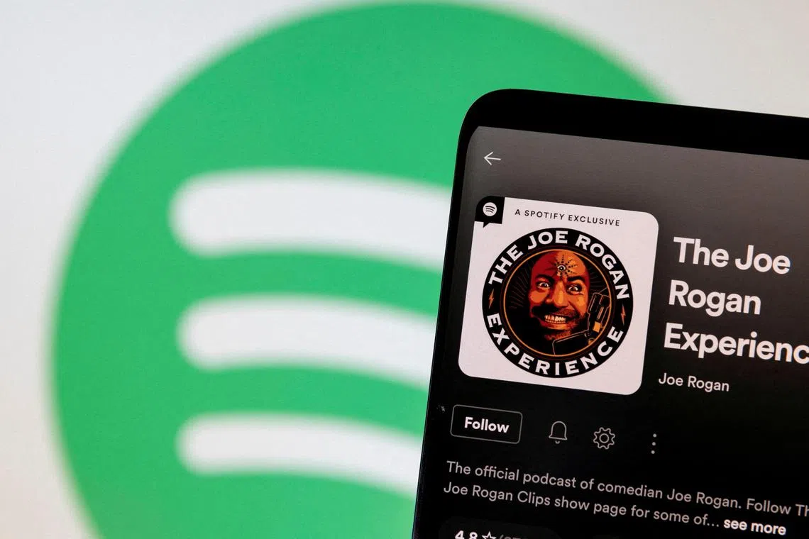 FILE PHOTO: Joe Rogan's Spotify profile is seen in front of displayed Spotify logo in this photo illustration taken, February 7, 2022. REUTERS/Dado Ruvic/Illustration/File Photo