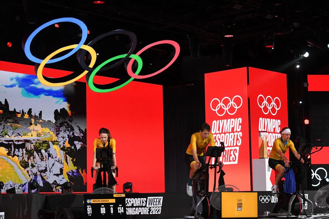 Team Fuego (in yellow) competing in the e-cycling finals at the inaugural Olympics Esports Week in Singapore on June 23. 