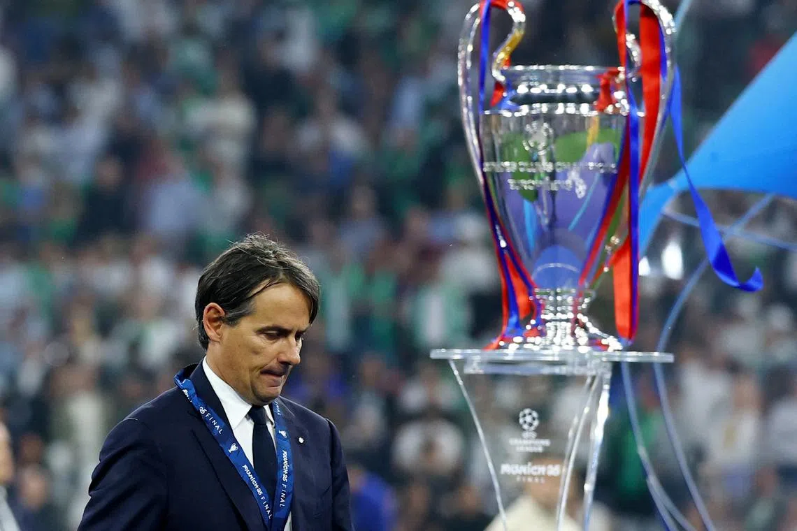 Soccer Football - Champions League - Final - Paris St Germain v Inter Milan - Allianz Arena, Munich, Germany - May 31, 2025 Inter Milan coach Simone Inzaghi looks dejected as he walks past the Champions League trophy after collecting his runners up medal REUTERS/Kai Pfaffenbach