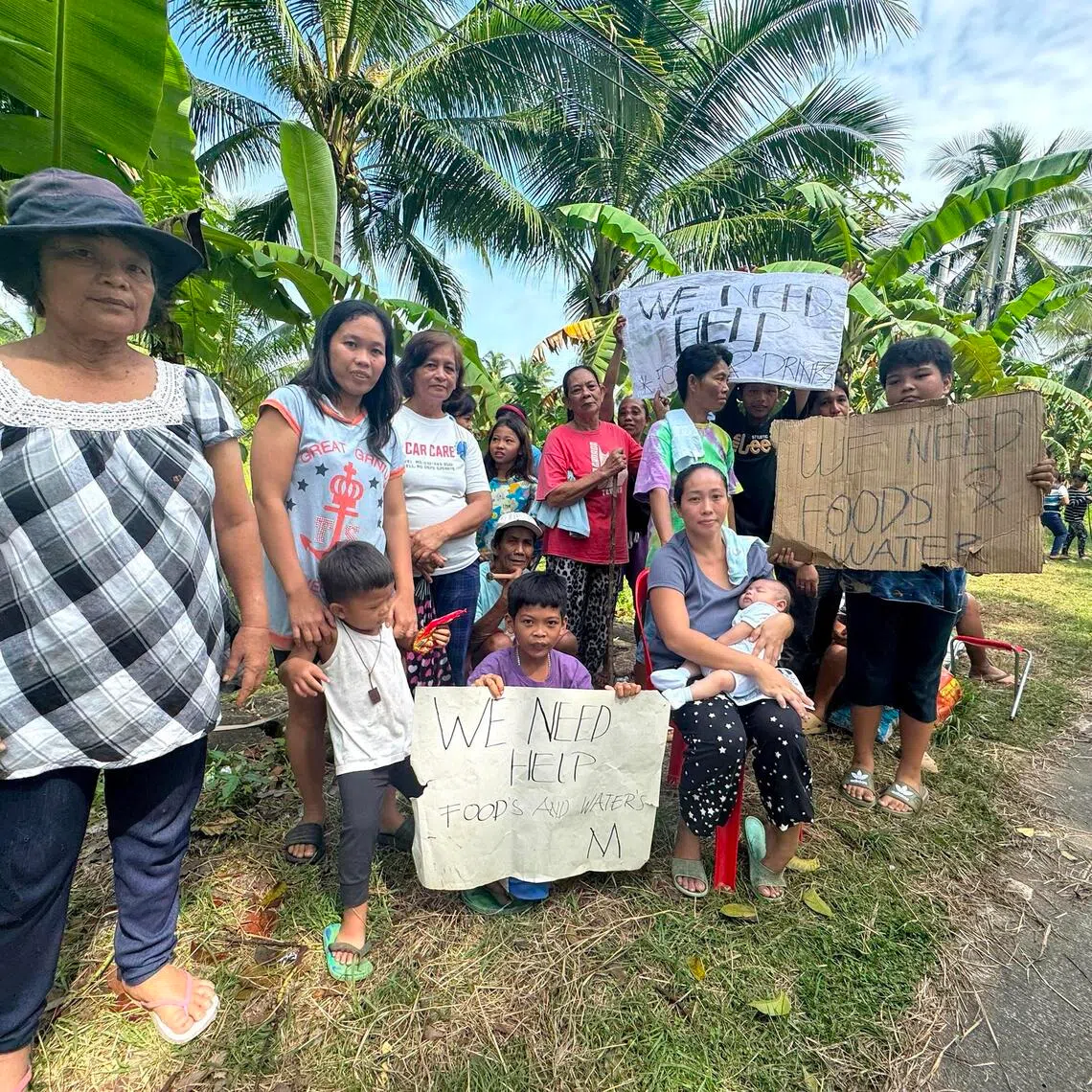 maaid - Cradling her two-month-old son, housewife Leira Macasero joins her neighbours in begging for food and water on the side of a highway in Daanbantayan town after a 6.9- magnitude earthquake struck Cebu, Philippines on Sept 30, 2025.

Credit Mara Cepeda/ST for all photos