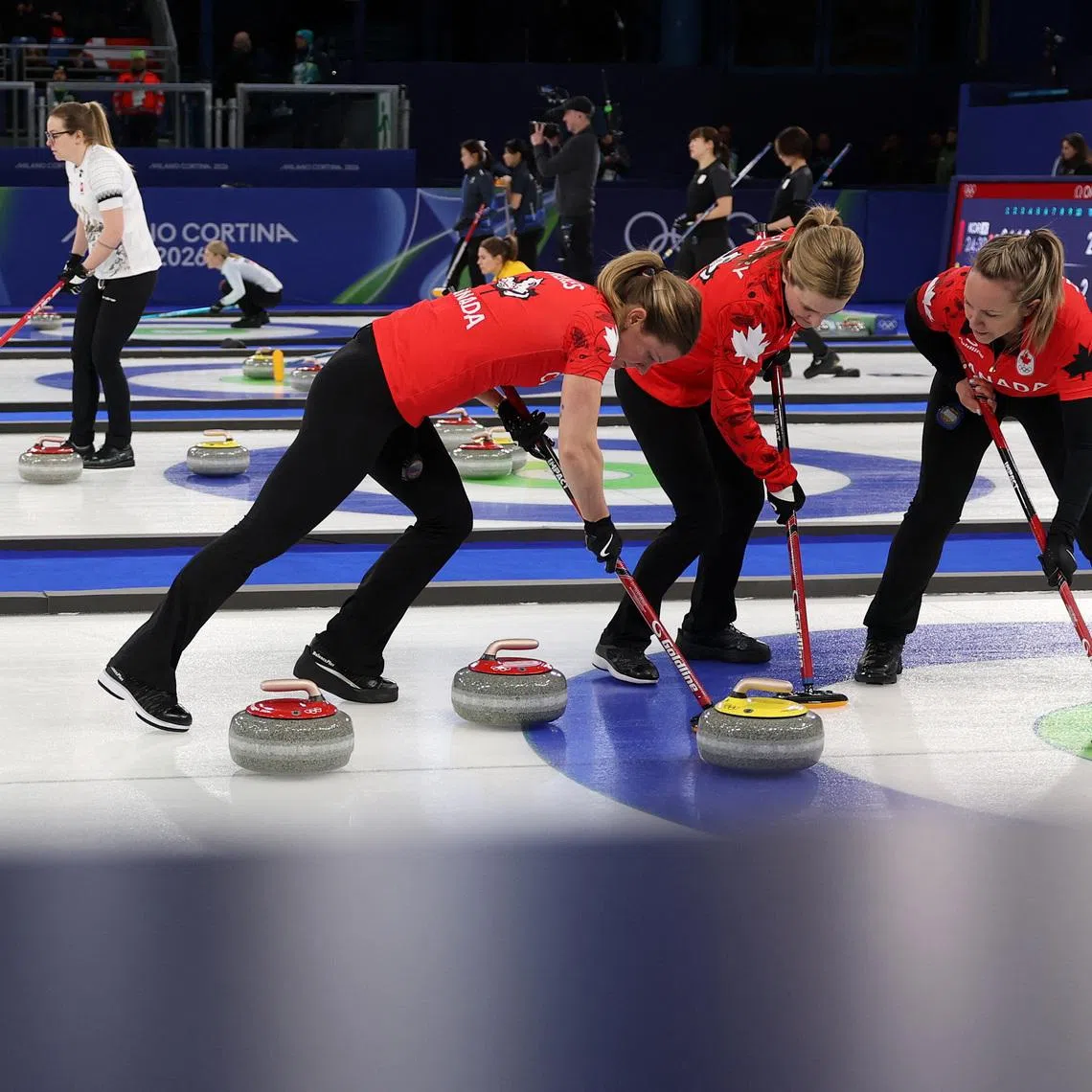 Milano Cortina 2026 Olympics - Curling - Women's Round Robin Session 1 - Canada vs Denmark - Cortina Curling Olympic Stadium, Cortina d'Ampezzo, Italy - February 12, 2026. Rachel Homan of Canada, Sarah Wilkes of Canada and Tracy Fleury of Canada during their match against Denmark in Women's Round Robin Session 1. REUTERS/Issei Kato