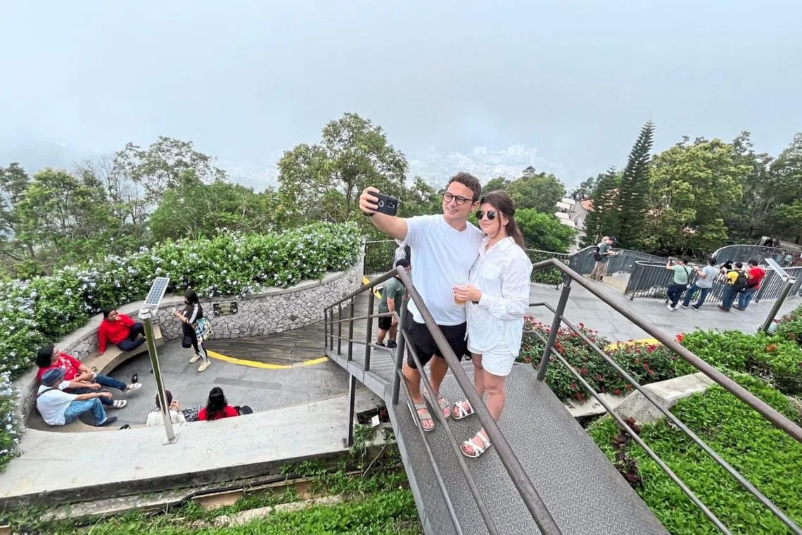 New Zealanders Steph Brownlee and her boyfriend Mr Thomas English retreated from the scorching heat in the city for the greenery on Penang Hill.