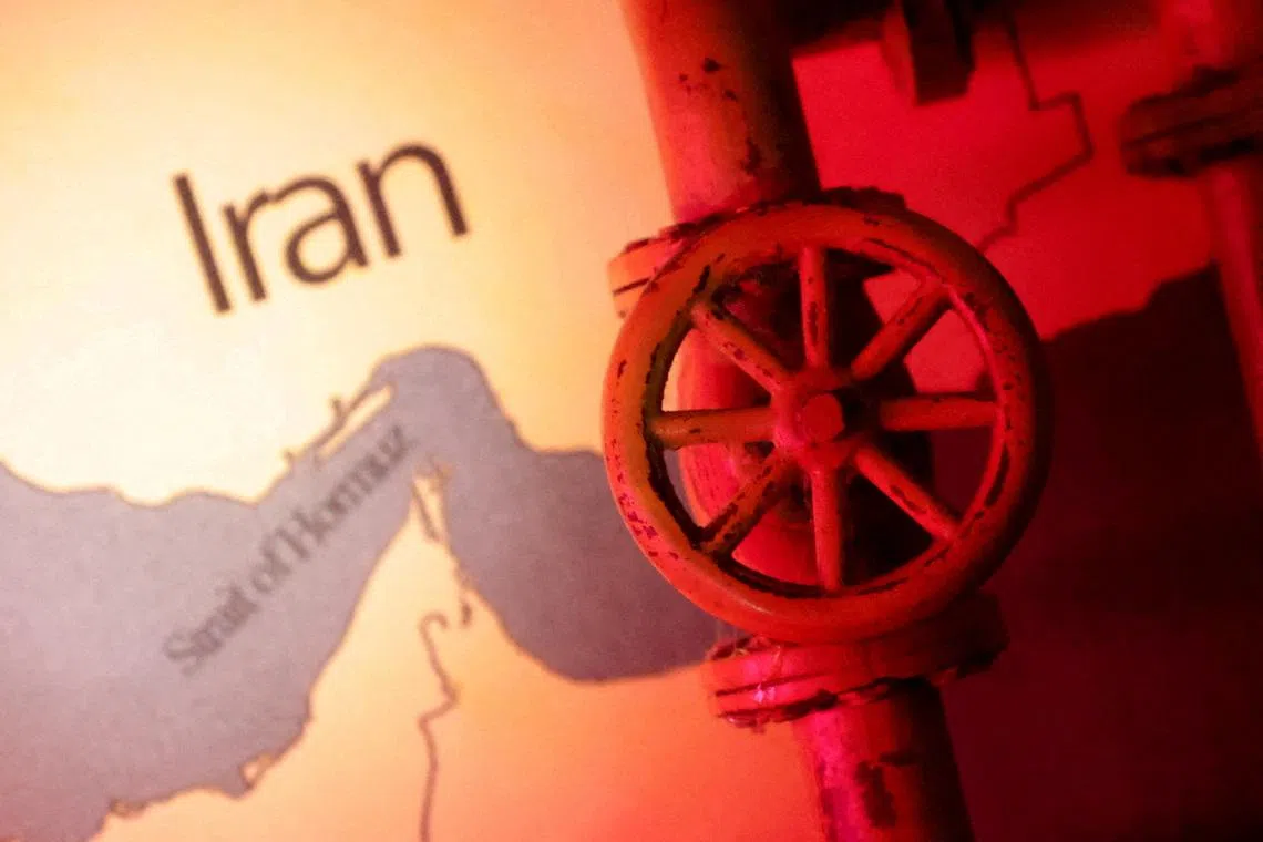 FILE PHOTO: A map showing the Strait of Hormuz and Iran is seen behind a 3D printed oil pipeline in this illustration taken June 22, 2025. REUTERS/Dado Ruvic/Illustration/File Photo