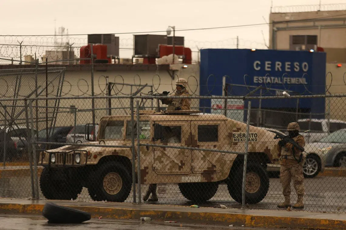 Members of the Mexican Army secure an area outside a prison in Ciudad Juarez, Mexico's Chihuahua state, after an armed attack in the facility. 