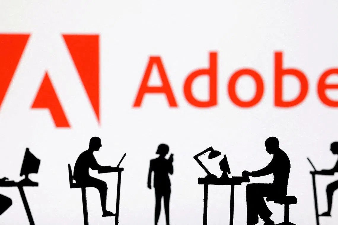 FILE PHOTO: Figurines with computers and smartphones are seen in front of Adobe logo in this illustration taken, February 19, 2024. REUTERS/Dado Ruvic/Illustration/File Photo