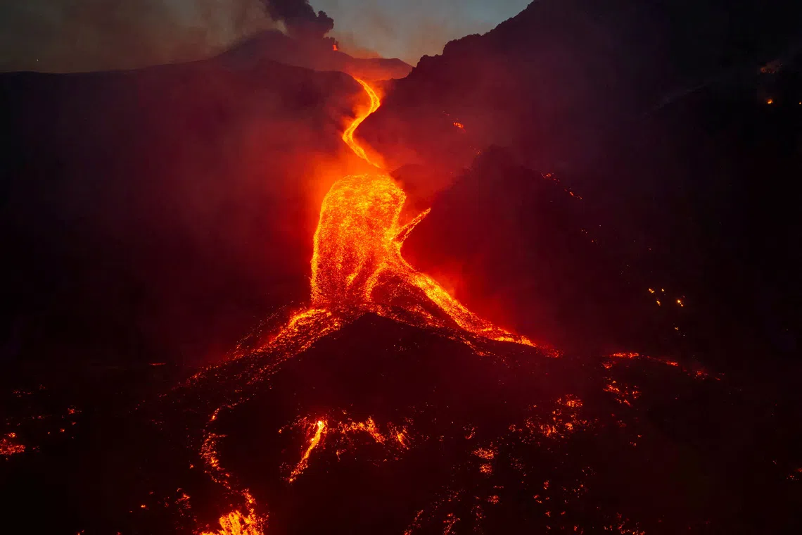 A drone view shows molten lava flowing down the slope  during an eruption at Mount Etna in Sicily, Italy, August 11, 2026.  Giuseppe Di Stefano/Etna Walk/via REUTERS