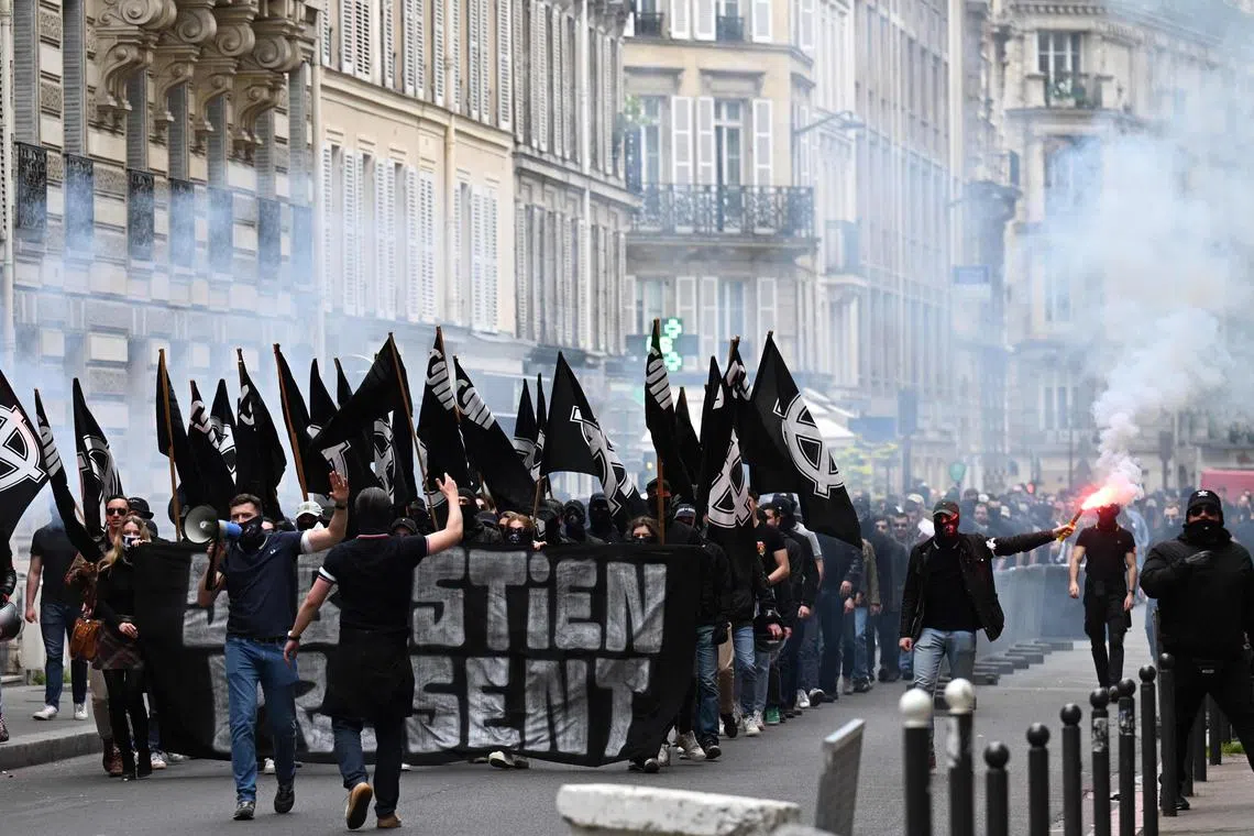 Men from far-right groups march to commemorate the death of a far-right activist, in Paris on Saturday.