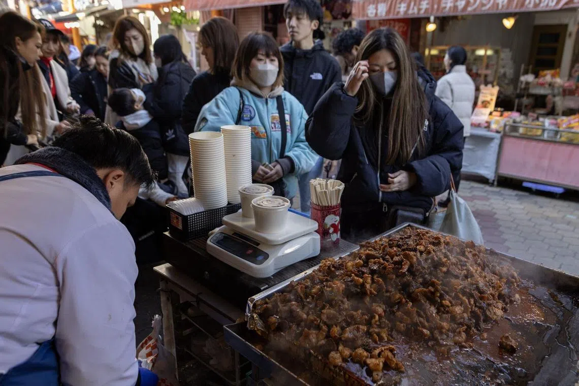 Customers wait in line to purchase meat in Ikuno Korean town in Osaka, Japan, on Sunday, Dec. 17, 2023. Japan is scheduled to release consumer price index (CPI) figures on Dec. 22. Photographer: Buddhika Weerasinghe/Bloomberg