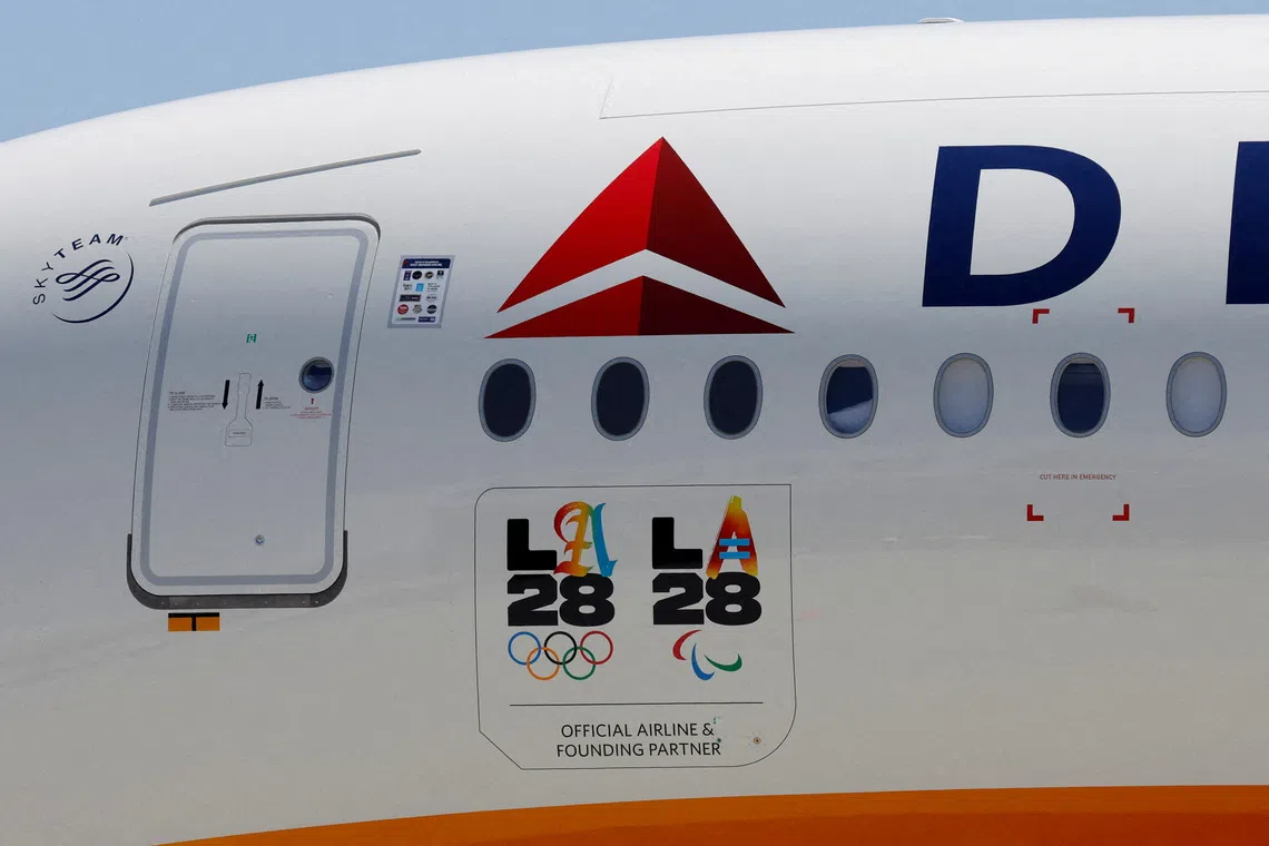 FILE PHOTO: LA28 logos are seen on a Delta Airlines jet carrying American athletes and officials and the Olympic flag as it arrives in Los Angeles, California, U.S. August 12, 2024. REUTERS/Carlin Stiehl/File Photo
