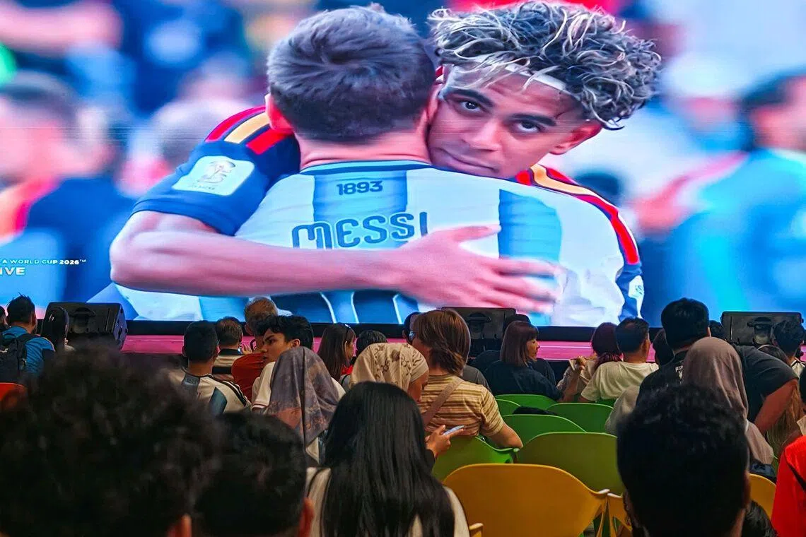 Fans watching Spanish winger Lamine Yamal hugging Argentina's Lionel Messi after the FIFA World Cup 2026 final between Argentina and Spain at Our Tampines Hub in the early hours of July 20, 2026. ST PHOTO: BRIAN TEO