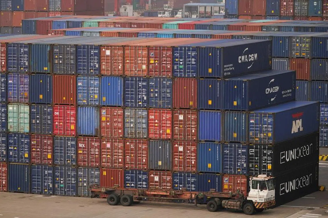 FILE PHOTO: A truck is seen next to containers at the Yangshan Deep Water Port in Shanghai, China, January 13, 2022. Picture taken January 13, 2022. REUTERS/Aly Song/File Photo