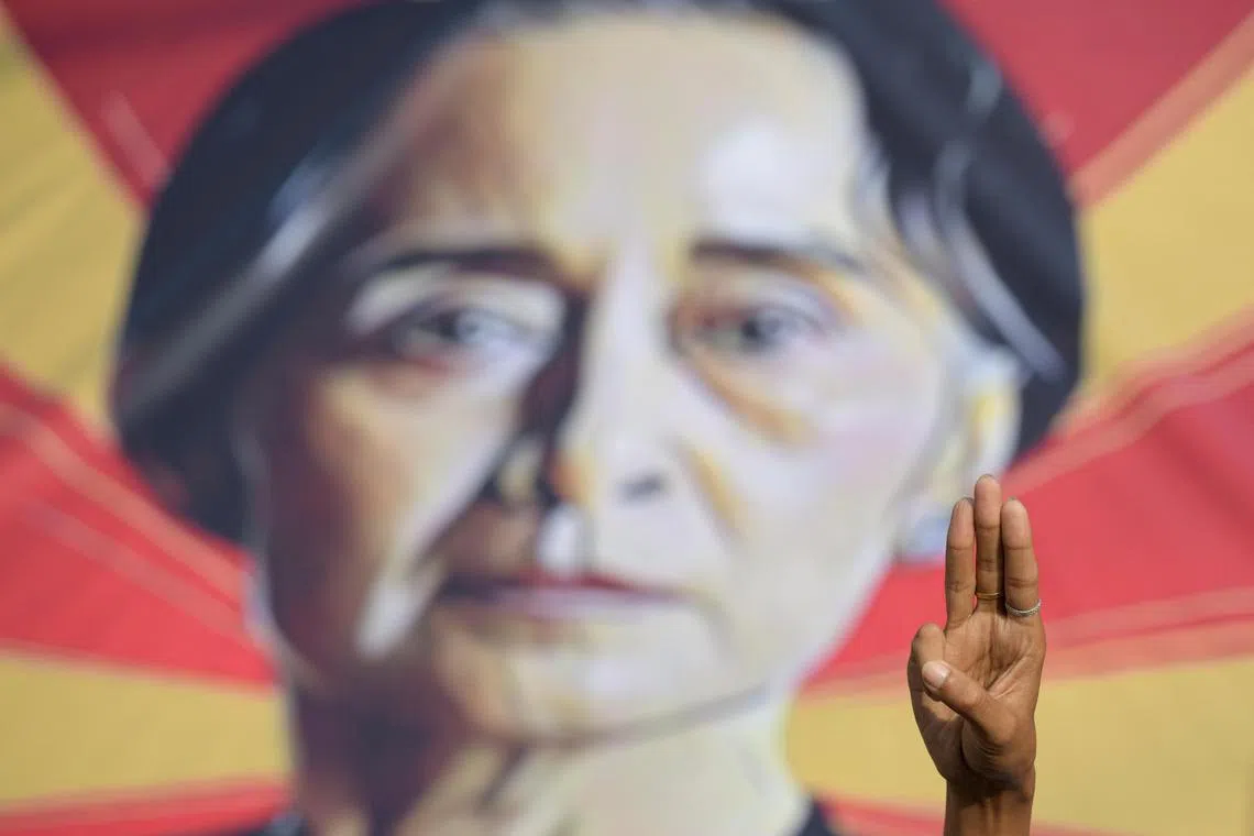 A person shows the three-fingers salute during a protest in Yangon on Feb 15, 2021.