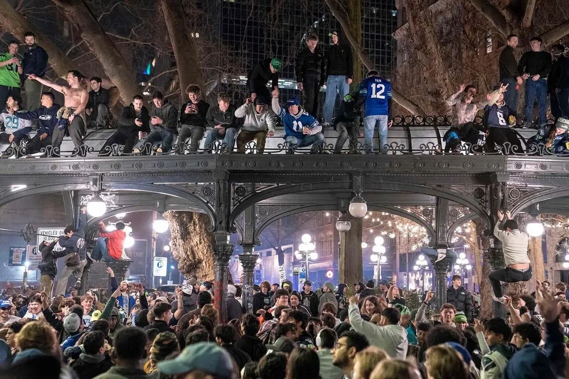 Seattle Seahawks fans celebrating atop a historic pergola in the Pioneer Square neighbourhood after their team won Super Bowl LX on Feb 8, 2026 in Seattle, Washington. The Seahawks defeated the New England Patriots 29-13. 
