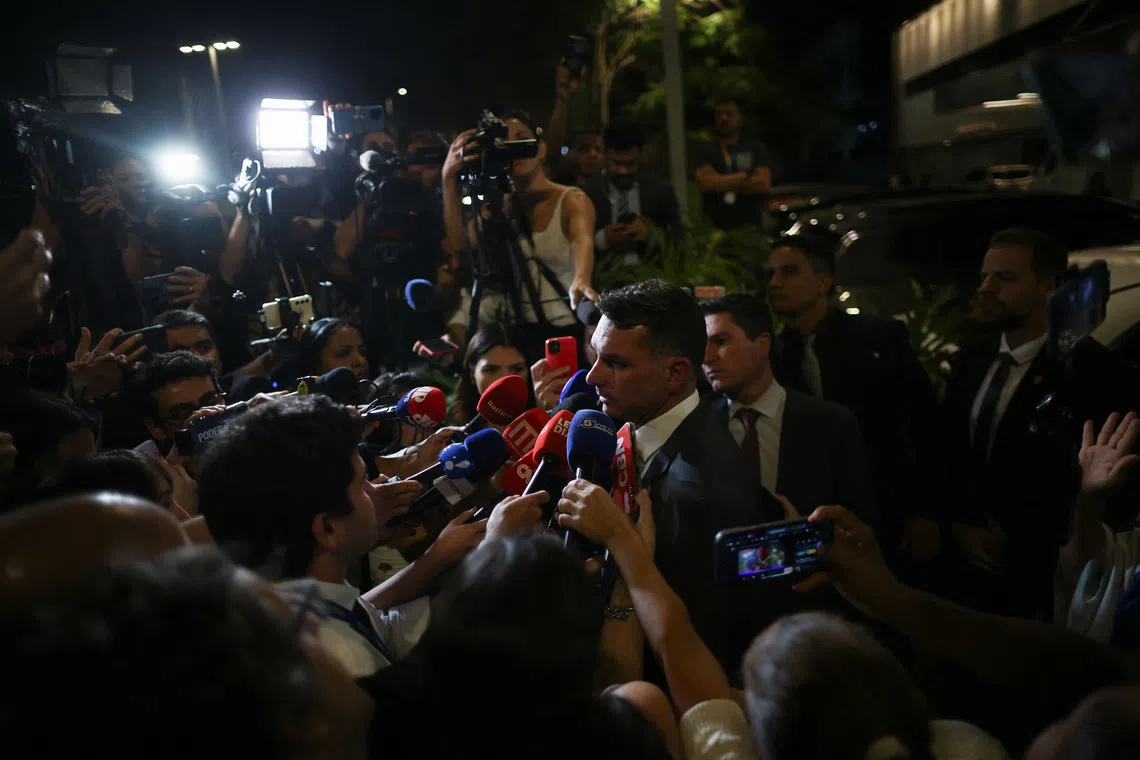 Senator Flavio Bolsonaro, son of former Brazilian President Jair Bolsonaro, speaks to the media outside the hospital where his father was taken after feeling sick, according to him, following his sentencing last week by a Supreme Court panel to 27 years and three months in prison for plotting a coup after losing the 2022 election, in Brasilia, Brazil, September 16, 2025. REUTERS/Adriano Machado