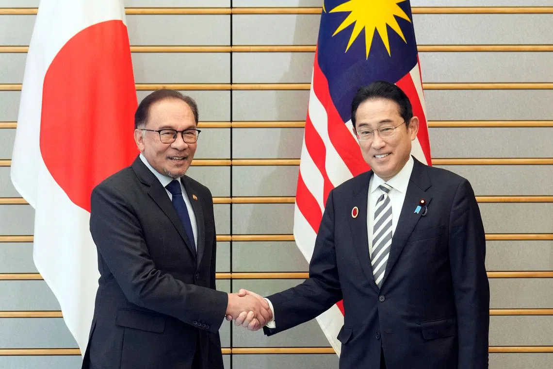 Malaysian Prime Minister Anwar Ibrahim (left) meets Japan Prime Minister Fumio Kishida at the start of their bilateral meeting in Tokyo, on Dec 16.