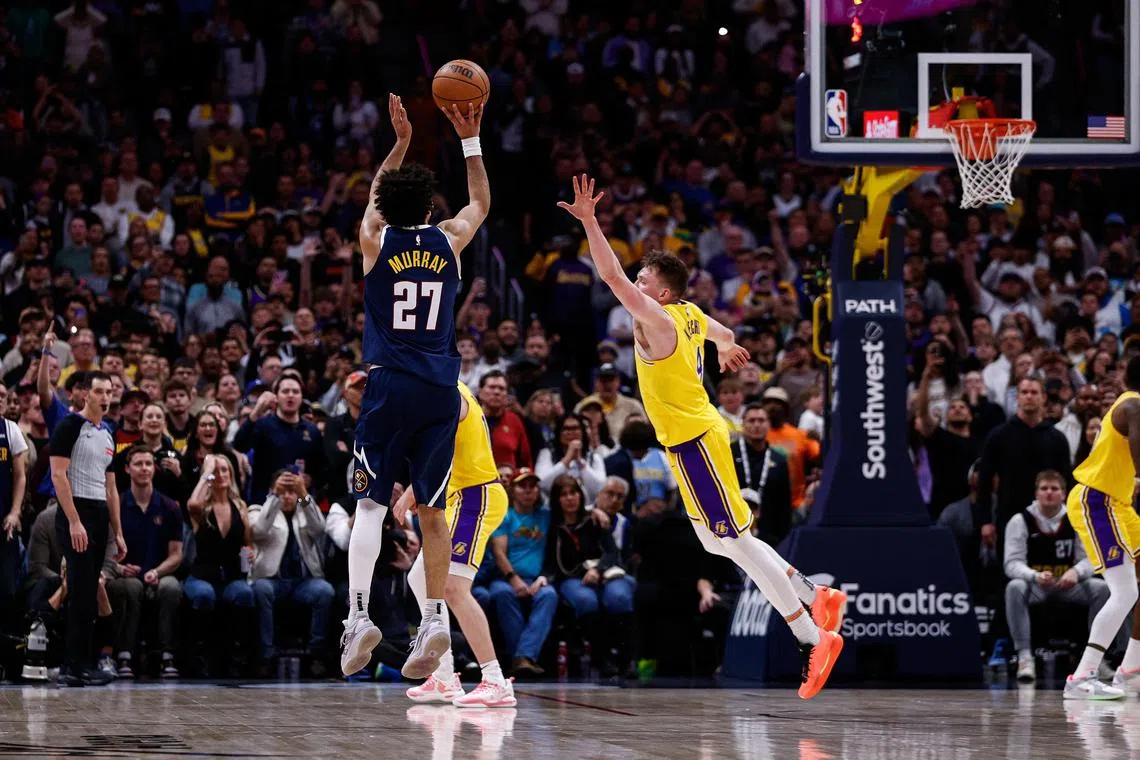 Denver Nuggets guard Jamal Murray attempts a shot against Los Angeles Lakers guard Dalton Knecht in the fourth quarter at Ball Arena.