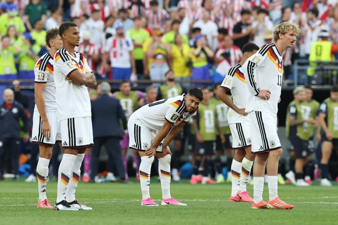 Soccer Football - FIFA World Cup 2026 - Round of 32 - Germany v Paraguay - Boston Stadium, Foxborough, Massachusetts, U.S. - June 29, 2026 Germany's Nick Woltemade, Malick Thiaw and Nadiem Amiri react after Germany's Jonathan Tah missed a penalty during a penalty shootout IMAGN IMAGES via Reuters/Amanda Perobelli