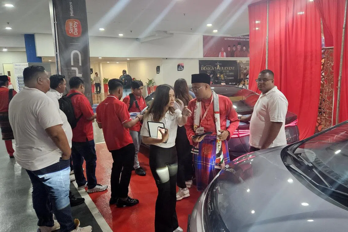 BYD booth's sales representative explaining the EV model to Pahang Umno local leaders.

Credit: Lu Wei Hoong