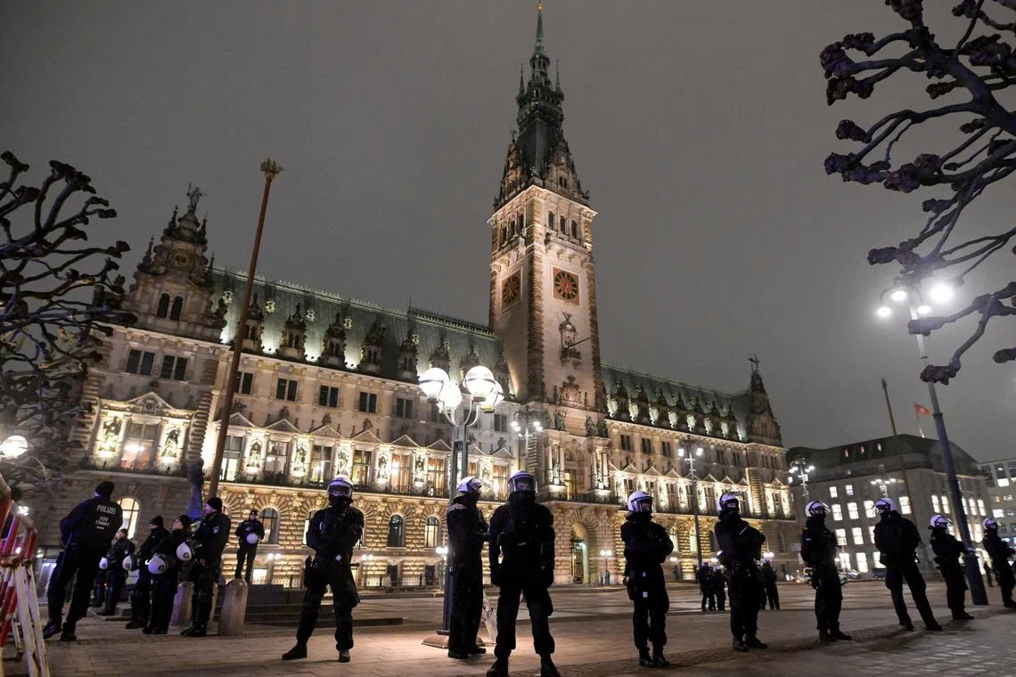 FILE PHOTO: Police officers stand guard in front of Hamburg's town hall where the far-right Alternative for Germany party (AfD) was holding a meeting, in Hamburg, Germany, January 16, 2025. REUTERS/Fabian Bimmer/File Photo