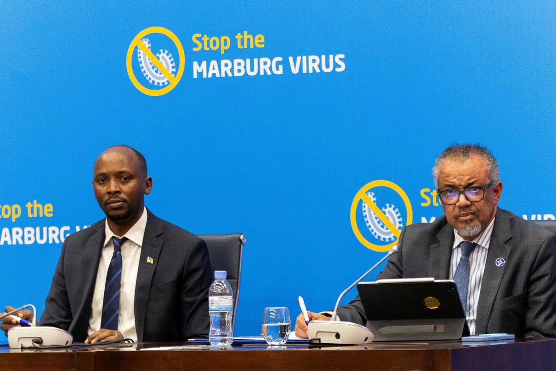 FILE PHOTO: World Health Organization Director-General Tedros Adhanom Ghebreyesus flanked by Rwanda’s Minister of Health, Sabin Nsanzimana address a press conference on the Marburg virus outbreak at the Kigali Convention Center in Kigali, Rwanda, October 20, 2024. REUTERS/Jean Bizimana/File Photo